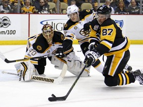 Pittsburgh Penguins' Sidney Crosby (87) tries to shoot in front of Boston Bruins' Torey Krug (47) and goalie Tuukka Rask, rear, during the second period of an NHL hockey game in Pittsburgh on Sunday, Jan. 22, 2017.