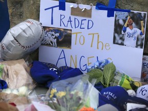 Signs and flowers make up a memorial for Kansas City Royals baseball pitcher Yordano Ventura outside Kauffman Stadium in Kansas City, Mo., Sunday, Jan. 22, 2017. Ventura died Sunday in a car crash on a stretch of highway near the town of San Adrian in his native Dominican Republic. He was 25.