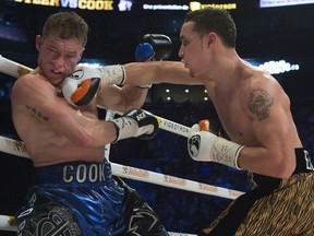 Steven Butler, right, lands a punch against Brandon Cook during their IBF/WBA light middleweight North American championship boxing match in Montreal on Saturday, Jan. 28, 2017.