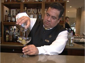 This Jan. 3, 2017, image taken from video shows Beverly Hilton hotel bartender Oscar Zuleta mixing drinks at the hotel in Beverly Hills, Calif. Zuleta has toasted with Sean Connery, gotten a head rub from Tom Hanks, shared a selfie with Jessica Alba while working previous Golden Globe Awards. The 48-year-old hotel staffer keeps the drinks flowing at the awards circuit's booziest gathering.