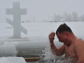 An Orthodox faithful dips into the icy waters of a lake on Jan. 19, 2015, during the celebration of the Epiphany holiday near the village of Sretinka. Among Orthodox Christians, the feast of Epiphany celebrates the day the spirit of God descended upon believers in the shape of a dove during Jesus Christ's baptism in the river Jordan.