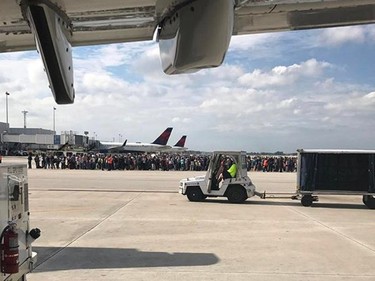 Photo courtesy of Taylor Elenburg shows Passengers gathering on the tarmac of the Fort Lauderdale-Hollywood airport in Florida after a gunman opened fire on January 06, 2017.  A gunman opened fire Friday at Fort Lauderdale-Hollywood airport in Florida, causing multiple fatalities, officials said. "Confirmed: Shooting at Fort Lauderdale-Hollywood International Airport with multiple people dead. One subject in custody," the Broward County Sheriff's office said in a tweet. Mayor Barbara Sharief said there was one shooter who was now in custody. She said the motive for the attack was not yet known.  /