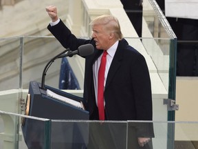 US President Donald Trump salutes the crowd after the swearing-in ceremony as 45th President of the USA in front of the Capitol in Washington on January 20, 2017.  /