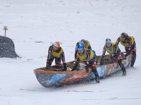 The Groupe Voyages Québec women's canoe team makes its way to the finish line during the 5th edition of the canoe ice challenge in Montreal on Sunday, Feb. 12, 2017.