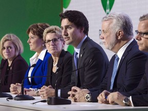 Quebec Premier Philippe Couillard and other premiers look on as Prime Minister Justin Trudeau speaks in 2015.