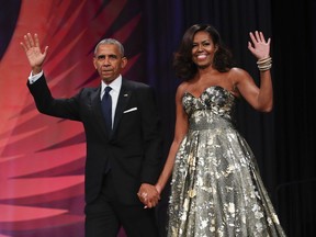 This Sept. 17, 2016 file photo shows President Barack Obama and first lady Michelle Obama at the Congressional Black Caucus Foundation's 46th Annual Legislative Conference Phoenix Awards Dinner in Washington. The former president an