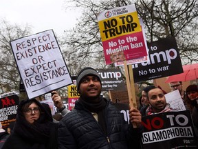 Demonstrators take part in a protest against United States President Donald Trump outside the U.S. Embassy in London on February 4, 2017.