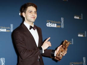 Canadian director Xavier Dolan poses with the Best Editing Cesar Award during the 42nd Cesar Film Awards ceremony at Salle Pleyel in Paris, Friday, Feb. 24, 2017. This annual ceremony is presented by the French Academy of Cinema Arts and Techniques.