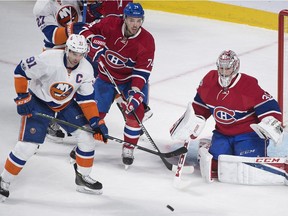 Canadiens goaltender Carey Price makes a save against Islanders captain John Tavares as Habs' Alexei Emelin defends during first period Thursday night at the Bell Centre.