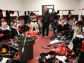 Coach John Chabot, centre, talks to the players in the dressing room in the reality TV series Hit the Ice.