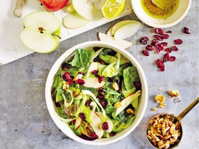 Salad from Oprah Winfrey's cookbook combines kale and other greens with dried cranberries and apples.