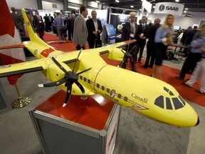 Delegates pass a model of the Airbus C295 fixed wing search and rescue aircraft at the Canadian Association of Defence and Security Industries' CANSEC trade show in Ottawa on Wednesday, May 27, 2015.