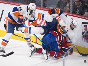 Islanders' Dennis Seidenberg collides with Canadiens' Alexander Radulov, bottom, as Islanders' Calvin de Haan moves in during second period in Montreal Thursday night.