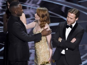 Class acts: Ryan Gosling, right, stands with his arms folded as Emma Stone congratulates Mahershala Ali for winning the award for best picture for Moonlight at the Oscars Feb. 26, 2017, at the Dolby Theatre in Los Angeles. It was originally announced mistakenly that La La Land was the winner.