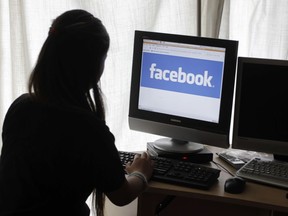 FILE - In this Monday, June 4, 2012, file photo, a girl looks at Facebook on her computer in Palo Alto, Calif. "Fake news," which has gotten a lot of attention for its potential role in swaying the 2016 presidential election, has fascinated researchers for some time. Their studies have yielded tools that help track how "alternative facts" spread, and others that let you identify fake stories or block them altogether. Some of these are still baby steps in dealing with the phenomenon, but they're part of a larger effort that now involves Facebook, Google and big media companies actively trying to tamp down the spread of fake stories.