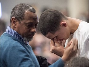 Ilies Soufiane, 15-year-old son of victim Azzeddine Soufiane, is consoled during a ceremony for three of the six victims of the Quebec City mosque shooting Feb. 3, 2017 in Quebec City.