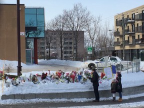 Flowers are laid outside the  Centre Culturel Islamique de Québec Saturday, Feb. 4, 2017.