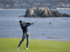 Jordan Spieth follows through on his approach shot from the fairway to the 18th green of the Pebble Beach Golf Links during the final round of the AT&T Pebble Beach National Pro-Am golf tournament Sunday, Feb. 12, 2017, in Pebble Beach, Calif. Spieth won the tournament by four strokes and finished at total 19-under-par.