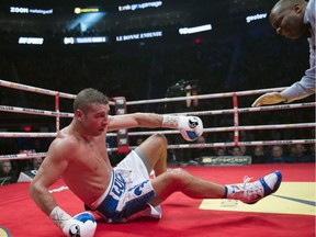Lucian Bute, of Montreal, falls to the floor after he was knocked down by Eleider "Storm" Alvarez, also of Montreal, during the Light Heavyweight bout, in Quebec City on Friday, February 24, 2017. Alvarez won the fight.