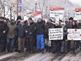 A few hundred people walk to the Quebec legislature at a march in solidarity to the victims of the mosque shooting, Sunday, February 5, 2017 in Quebec City. Leaders of the Muslim community, Mohamed Labidi, third from the left, and Mohamed Yangui, fourth, vice-president and president of the Quebec Islamic Cultural centre, stand together on the front row. Six people died in a shooting at a Quebec City mosque on Janu. 29.