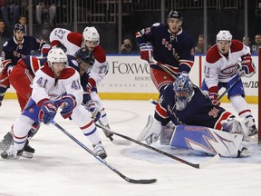 Canadiens winger Paul Byron tries to score on Rangers goalie Henrik Lundqvist as defenceman Marc Staal helps Lundqvist during first period in New York on Tuesday night.