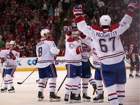 Alex Galchenyuk (#27) (C) of the Montreal Canadiens celebrates with Greg Pateryn (#8),  Max Pacioretty (#67) and Torrey Mitchell (#17) after scoring the game-winning goal against the Arizona Coyotes at Gila River Arena on February 9, 2017 in Glendale, Arizona. The Canadiens defeated the Coyotes 5-4 in overtime.