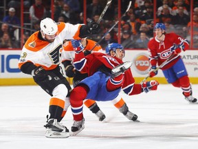Tomas Plekanec (#14) of the Montreal Canadiens is hit by Radko Gudas (#3) of the Philadelphia Flyers during the first period at the Wells Fargo Center on February 2, 2017 in Philadelphia, Pennsylvania.