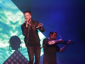 Ryan Tedder, right, lead singer of OneRepublic and Zach Filkins at the violin, perform during a show at the Bell Centre on Monday April 20, 2015.
