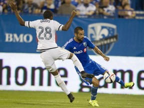 Andres Romero of the Montreal Impact (right) tries to get a shot past Raymon Gaddis of the Philadelphia Union in MLS action at Saputo Stadium in Montreal on Aug. 22, 2015.