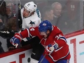 Montreal Canadiens' Michael McCarron checks San Jose Sharks' Justin Braun during third period NHL action in Montreal on Friday December 16, 2016.