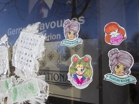 Stickers are plastered on the riding office window of Laurier-Dorion MNA Gerry Sklavounos, in Montreal, Feb. 10, 2017. The day before, he made a declaration as part of his bid to return to the provincial Liberal caucus after being cleared of sexual assault allegations.