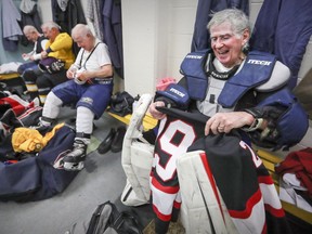 Ron Daley, 80, laughs with teammates as he gets undressed following old-timers hockey game at the Dorval Arena on Feb. 13, 2017.