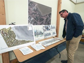 Fred van Noord looks at pictures and plans for the Sandy Beach residential project during a public meeting held by Nicanco Holdings in Hudson, west of Montreal Thursday February 16, 2017.