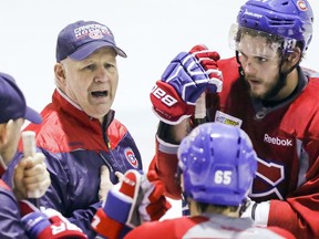 Coach Claude Julien speaks to Canadiens players as Alex Galchenyuk, right, pays close attention during practice.