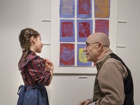 Liana Aoude talks to her grandfather, Tony Saroli, about her art during a vernissage held Sunday at the Galerie de la Ville in Dollard-des-Ormeaux.  The exhibit, which runs until March 19, is called Creating Culture and it spotlights the talent of children and teens involved in programs at the Dollard arts centre.