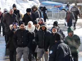 Members of the public arrive for the funeral of Abdelkrim Hassane, Khaled Belkacemi, and Aboubaker Thabti, in Montreal Feb. 2, 2017.