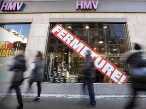 Pedestrians walk past the HMV store on Ste-Catherine St. in Montreal Thursday Feb. 2, 2017.  HMV stores in Canada are going out of business.
