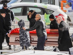 The coffin of one of the victims of the Quebec City mosque massacre is wheeled into the Maurice Richard Arena in Montreal Feb. 2, 2017, for a funeral with two other victims.