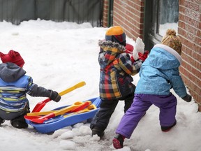 Children play in the snow at a CPE daycare in Montreal Feb. 21, 2017.