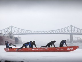 Participants from the Male Elite class push their canoes onto the St. Lawrence River at the Clock Tower Quay in Montreal's Old Port on Feb. 23, 2013. This year's event takes place Saturday and Sunday, Feb. 11-12, 2017.