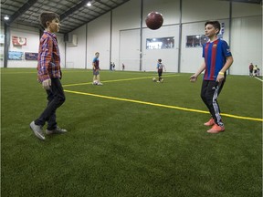 Brothers Keanou (left) and Kouroush Maroufi play a little soccer on the newly installed synthetic turf at the Complexe sportif de St-Lazare on Thursday, Feb. 23, 2017. Last week, the town of St-Lazare announced that drop-in soccer is back now that the synthetic turf surface has been replaced at the privately-owned complex. For the March 6-10 school break, the town has added extra hours for indoor pick-up soccer: 10 a.m. to noon and then 3:30 p.m. to 6 p.m. Monday to Friday.