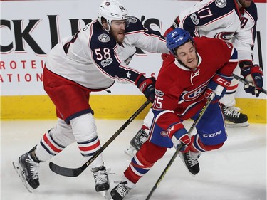 Columbus Blue Jackets' David Savard (58) hits Montreal Canadiens' Andrew Shaw (65) from behind, during second period NHL action in Montreal on Tuesday Feb. 28, 2017.