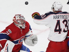 Columbus Blue Jackets' Scott Hartnell (43) tries to get his glove on flying puck in front of Montreal Canadiens goalie Carey Price, during second period NHL action in Montreal on Tuesday Feb. 28, 2017.