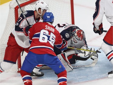 Montreal Canadiens' Andrew Shaw (65) tries to reach for puck next to Columbus Blue Jackets goalie Sergei Bobrovsky and defenceman Ryan Murray (27), during first period NHL action in Montreal on Tuesday February 28, 2017.