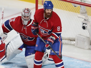 Montreal Canadiens' Jordie Benn (8) stands in from of Montreal Canadiens goalie Carey Price, during his first game as a Montreal Canadiens, during first-period NHL action in Montreal on Tuesday Feb. 28, 2017 against the Columbus Blue Jackets.