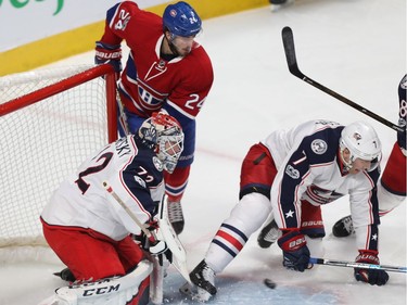 Montreal Canadiens' Phillip Danault (24) watches puck past Columbus Blue Jackets goalie Sergei Bobrovsky and Jack Johnson (7), during first period NHL action in Montreal on Tuesday Feb. 28, 2017.