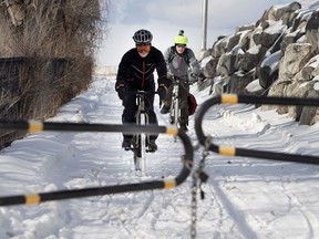 Eric Thibodeau, left, and Mario Grenier ride the south access ramp to the Jacques Cartier Bridge bike path in Montreal on Friday February 3, 2017. The pair want the bike path to remain open for the winter season.