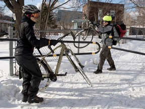 Éric Thibodeau, left, and Mario Grenier exit the south access ramp to the Jacques Cartier Bridge bike path on Feb. 3, 2017.