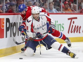 Canadiens' Alexander Radulov lifts the stick of  Washington Capitals' Alex Ovechkin in Montreal on Saturday, Feb. 4, 2017. Radulov was penalized for hooking on the play.