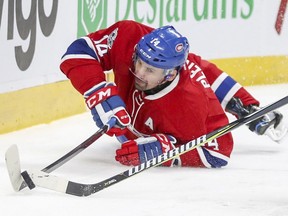 Montreal Canadiens' Tomas Plekanec tries to play the puck while falling during third period of National Hockey League game in Montreal Saturday February 4, 2017.